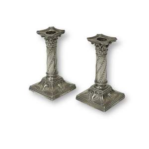 A Matched Pair of Silver Candlesticks by Edward Hutton of London